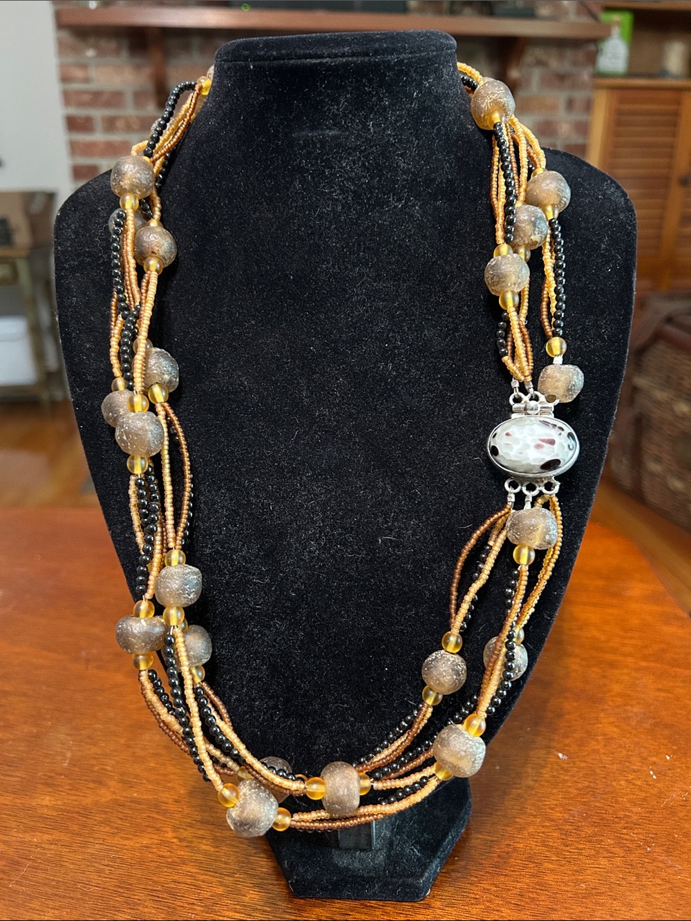 Sojourner Multi-Strand Amber and Black in Color Beaded Necklace.